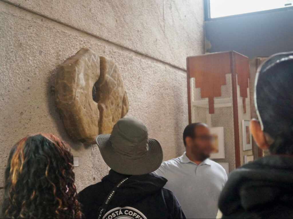 A man explaining things on tourists during a tour of Tibes Ceremonial Park