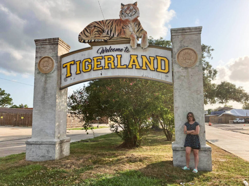 The author, Meg O’Connor with the welcome sign of Tigerland neighborhood