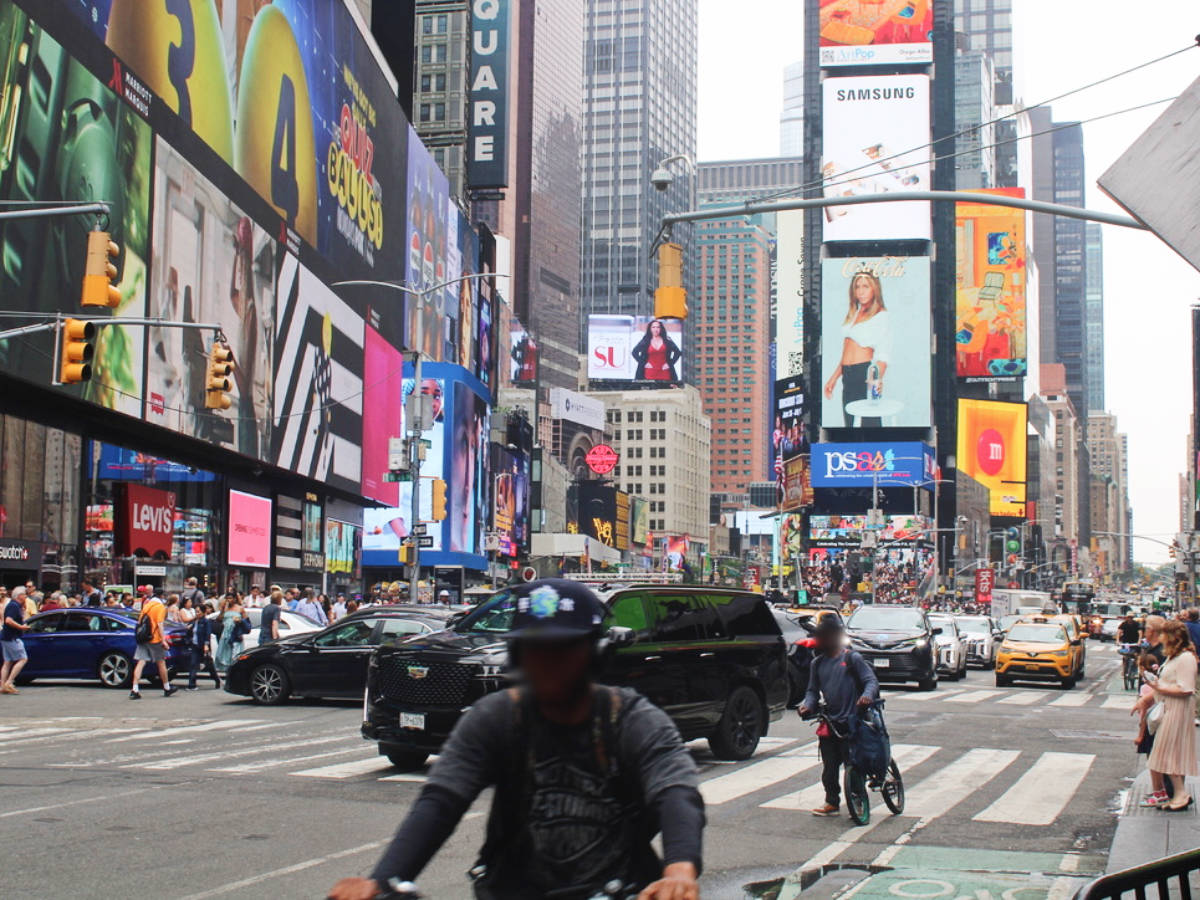 People and cars at Time Square during morning