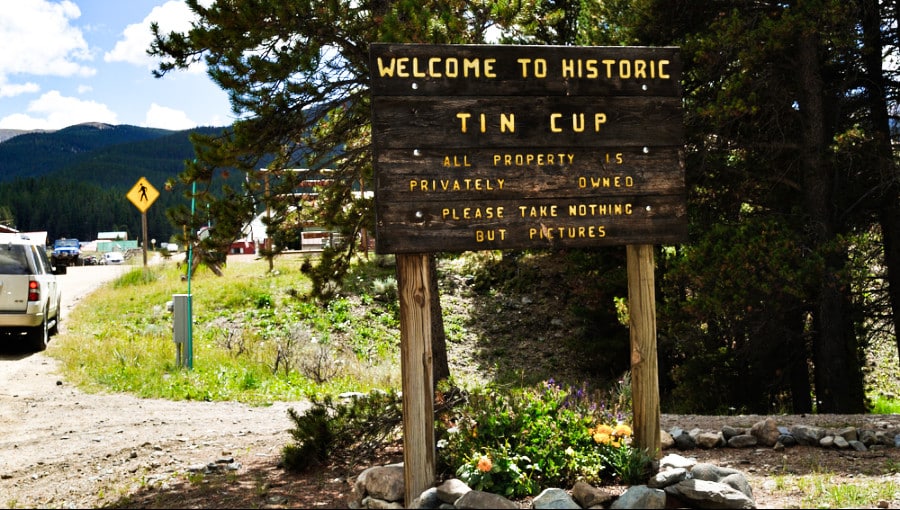 A welcome wooden sign of the historic Tin Cup placed near the road