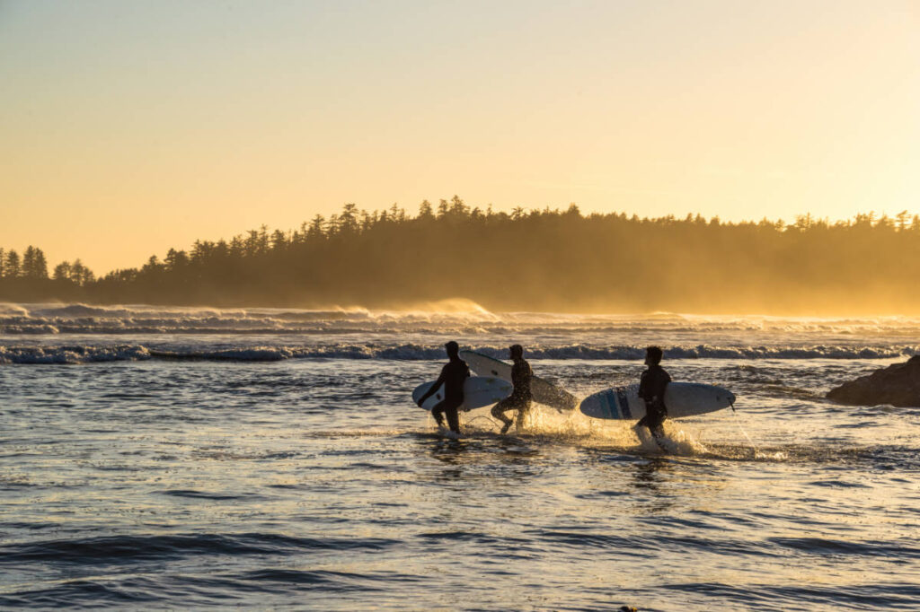Surfers carrying their surfboard at the Tofino’s Pacific Rim National Park