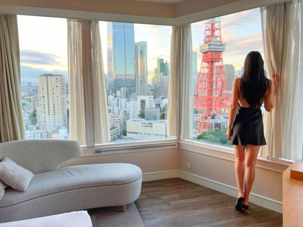 Writer Clara gazes out a window and admiring Tokyo Tower