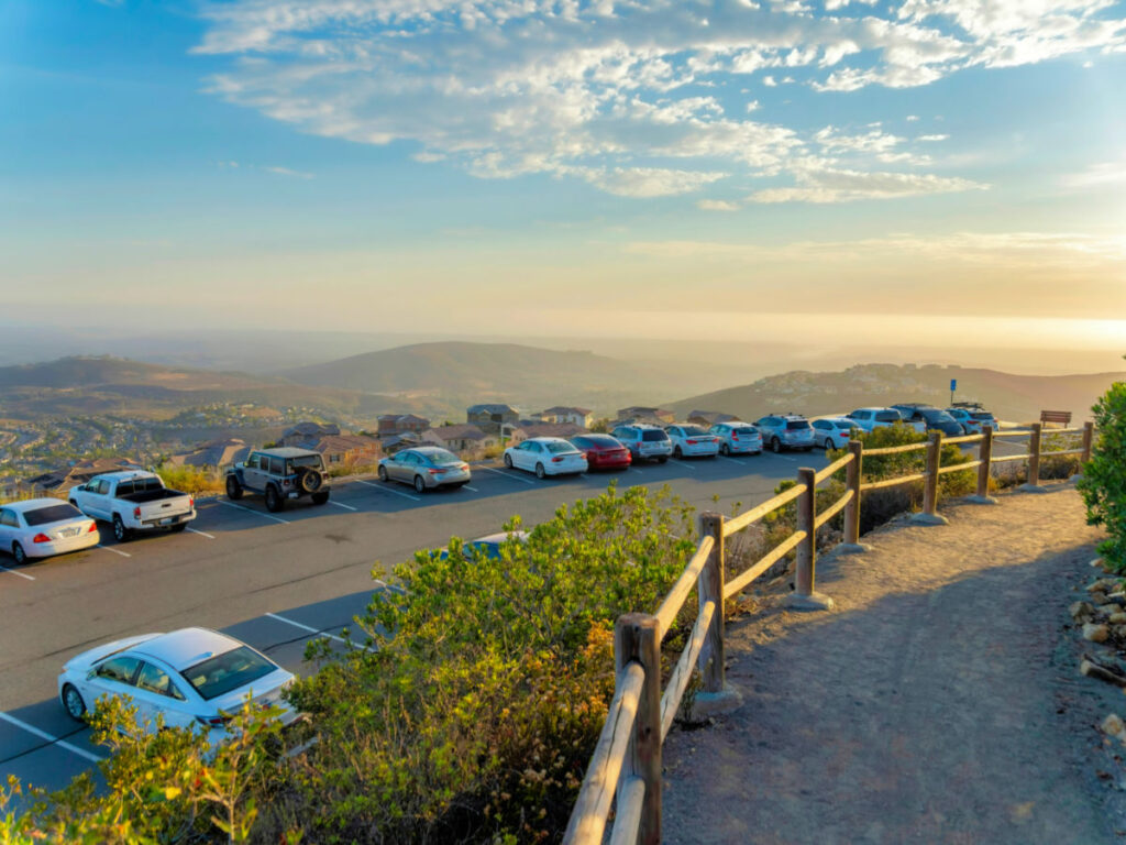 Parking lot and hiking trail at Double Peak with a view of the mountains