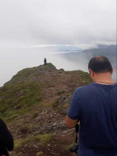 People at the topo of a mountain in Alaska