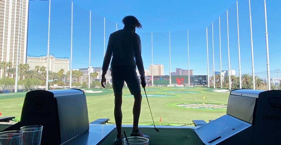 The author's partner playing golf in Topgolf Las Vegas