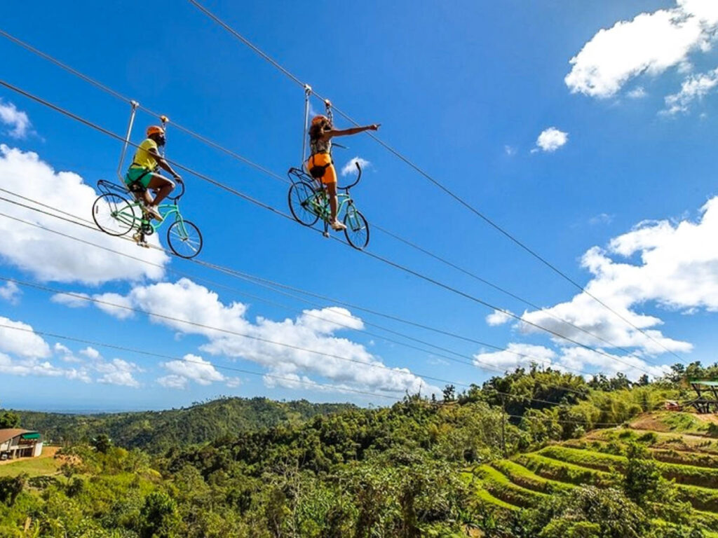 A couple riding the Toro Zipline Bikes in Puerto Rico on a sunny day