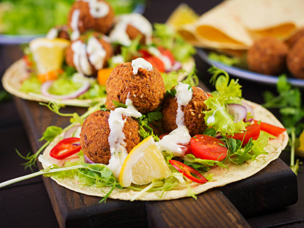 A serving of Tortilla wrap with falafel and fresh salad