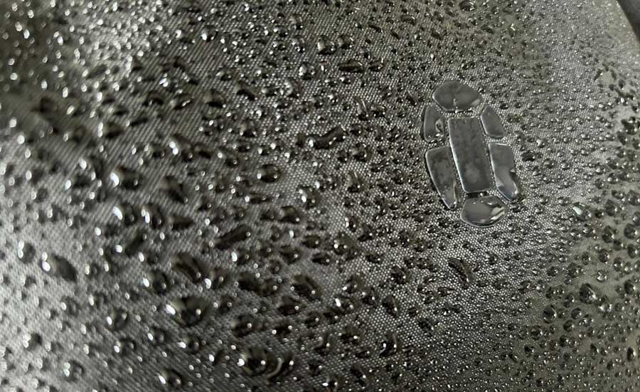 Close up view of water drops at the material used in Tortuga Travel Backpack