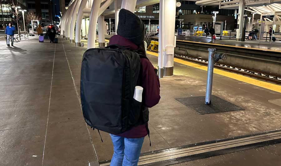Abigail carrying her Tortuga Travel Backpack