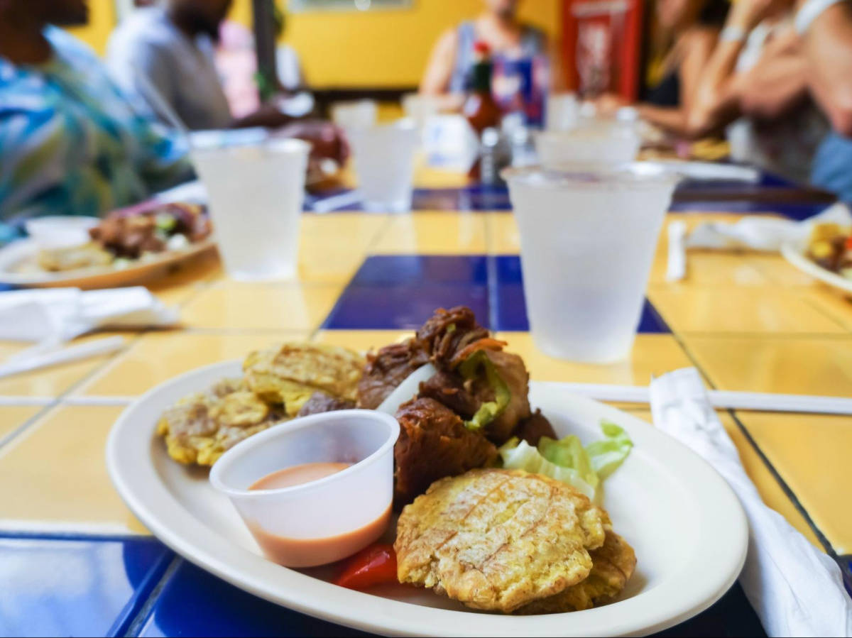 Closeup look of a plate with tostones and roasted pork from El Patio
