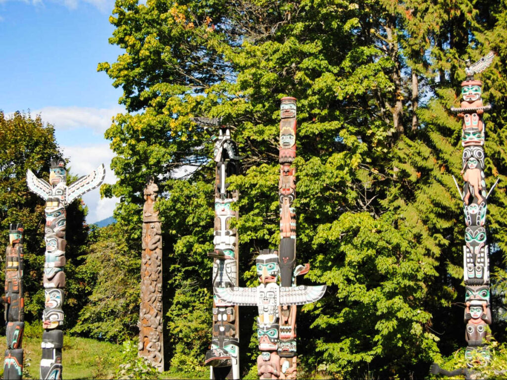 The totem poles surrounded by greenery at Stanley Park