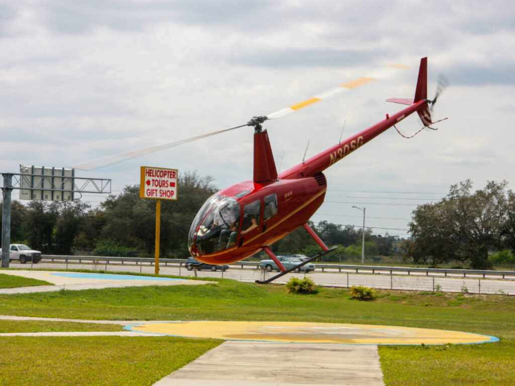Red tourist helicopter takes off for sightseeing journey