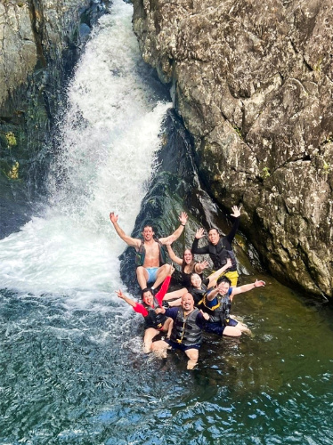 A group of tourists enjoying at the bottom of the waterfalls