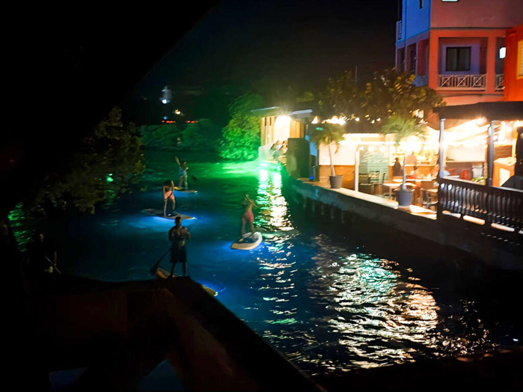 Overlooking view of the tourists paddleboarding in the Lobina Lagoon at Night