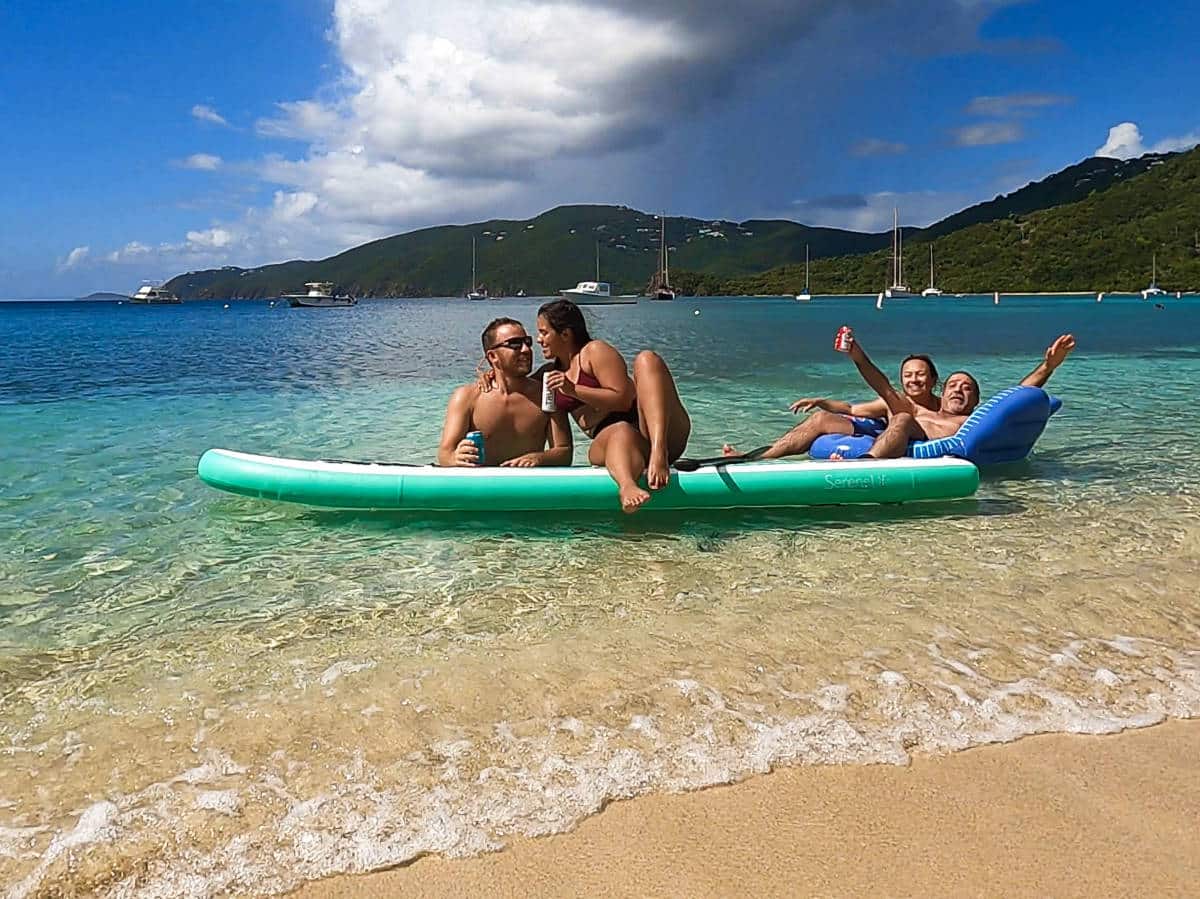 Group of tourists enjoying at the shoreline of Brewers Bay