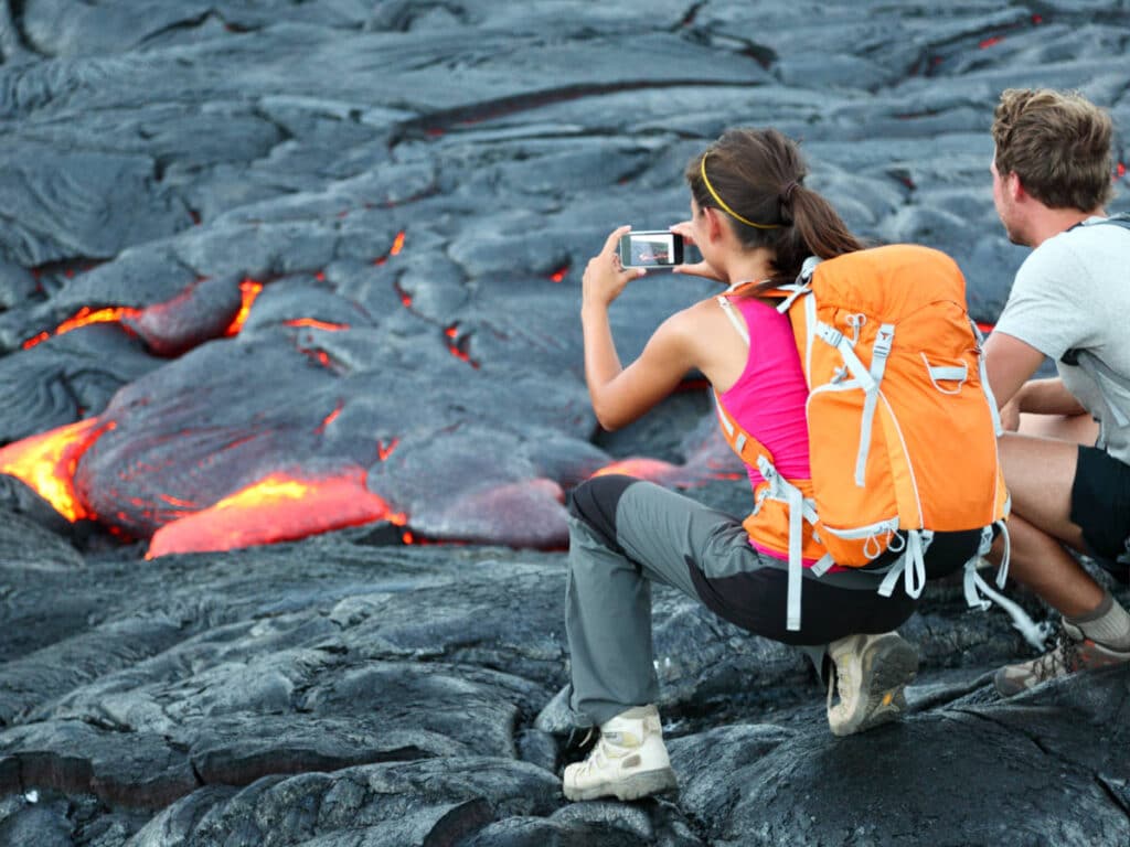 View of the tourists taking a photo of the lava at Hawai’i Volcanoes National Park