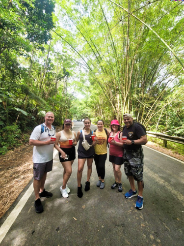 Group of tourists, posing in the middle of the rainforest in El Yunque