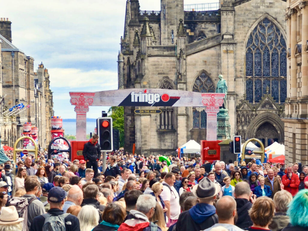 The crowd at the Royal Mile during a festival on a sunny day