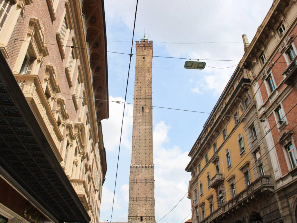 View of the tower in the middle of the street in Bologna