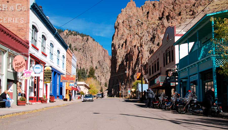View of motorcycles parked alongside a street in Creede, Colorado