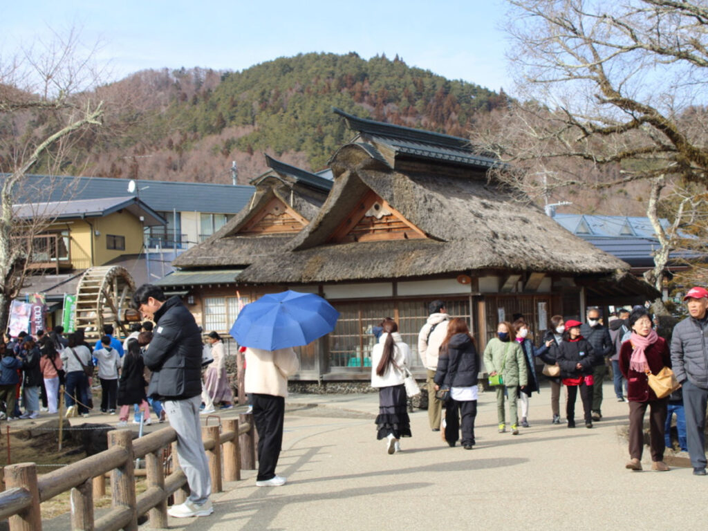 Groups of people exploring the town of Oshino Hakkai