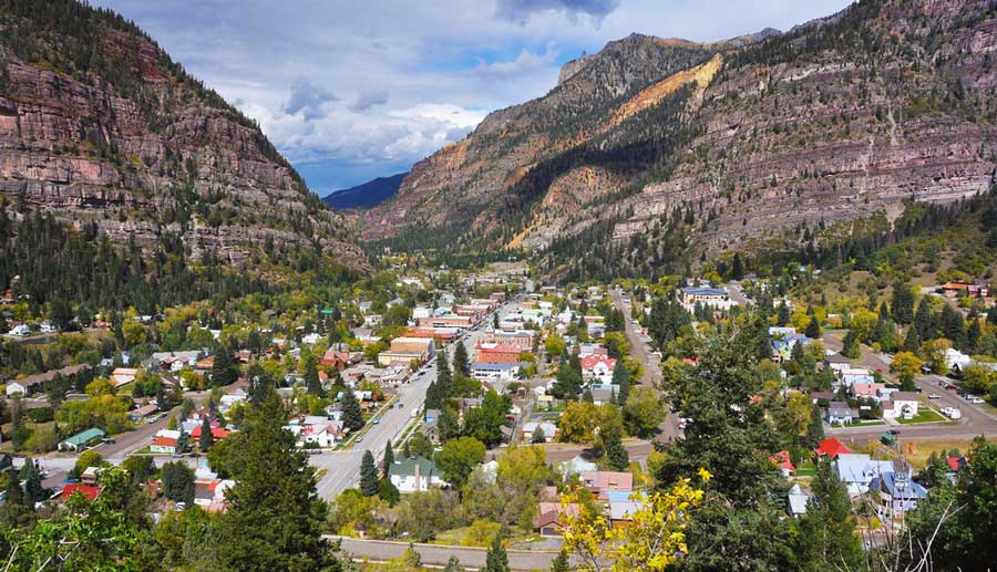 Aerial view of houses below the mountains