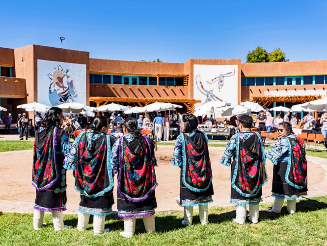 View of people on a traditional dance at the Indian Pueblo Cultural Center