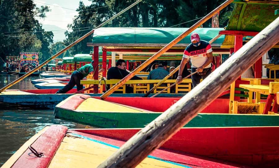 View of people riding a traditional trajineras in Xochimilco