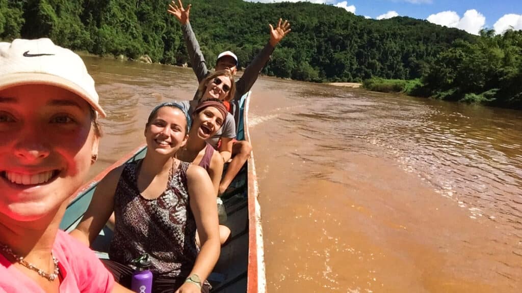McKenna with a group transporting on a boat along Louangphabang River