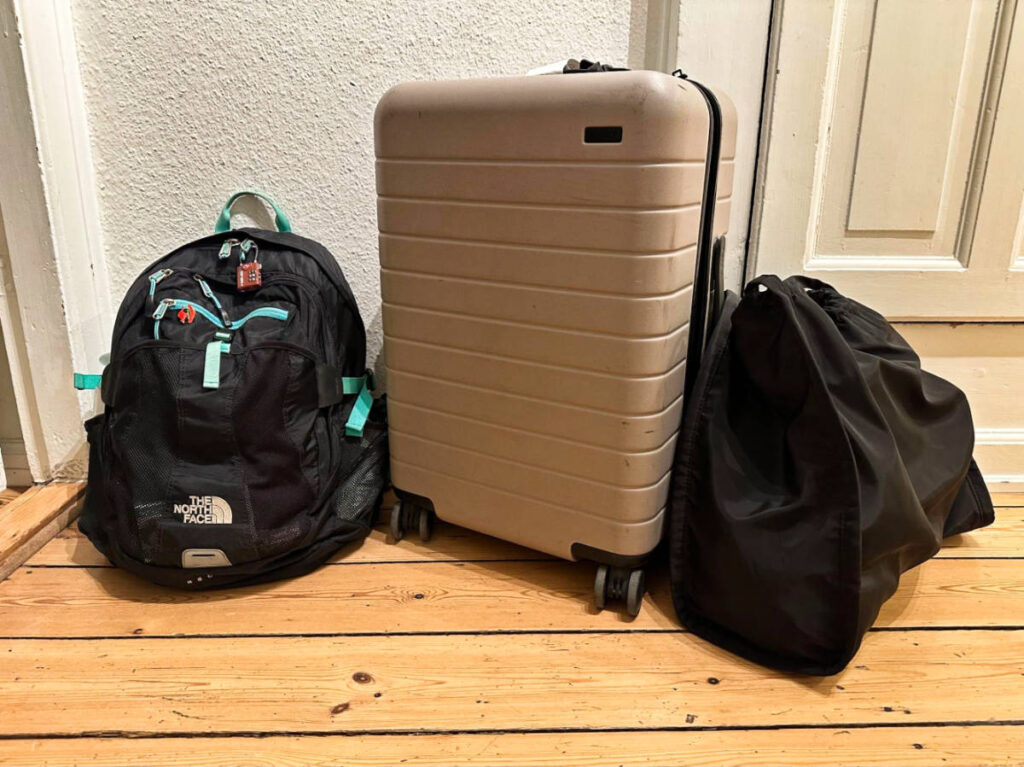 The travel luggage and daypacks on the wooden floor