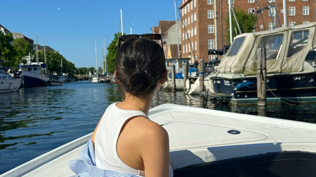 Travel Lemming Author Lea Rose looking ahead on a boat tour in Copenhagen