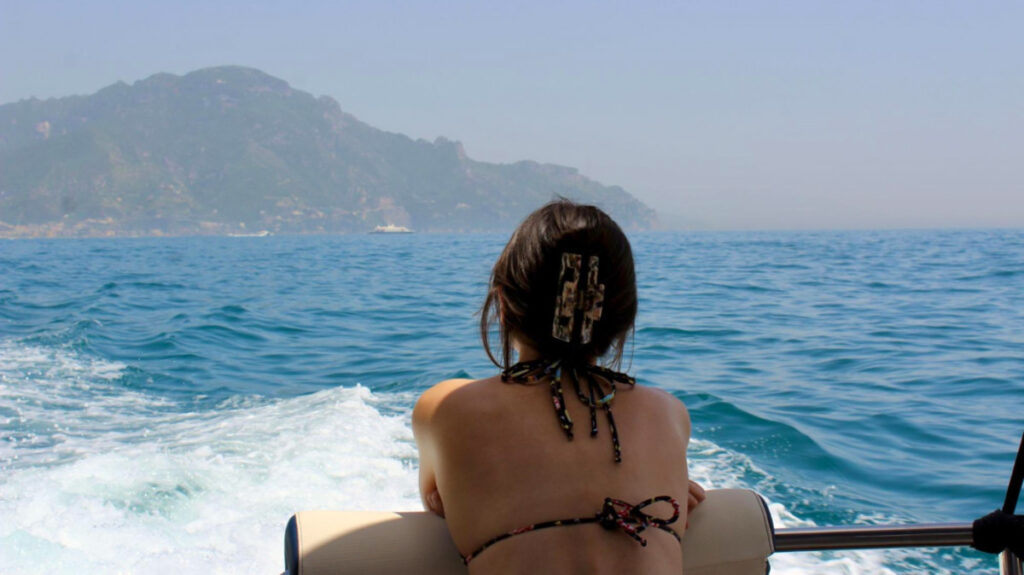 Travel Lemming Author Lea Rose watching the Amalfi Coast waves and scenery