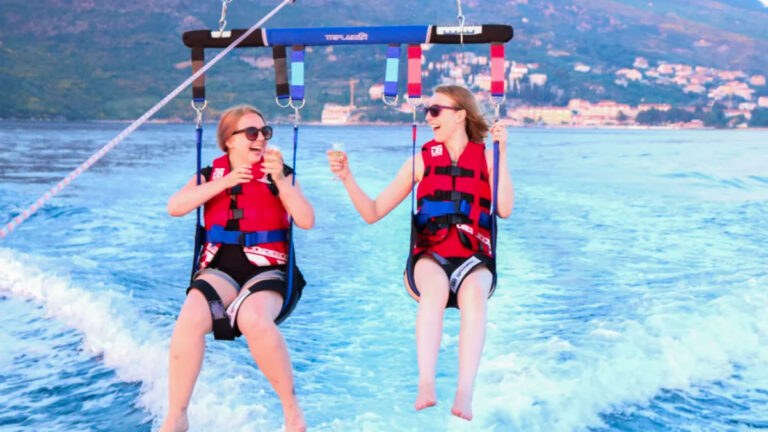 Travel Lemming Author Taylor and friend parasailing in Croatia