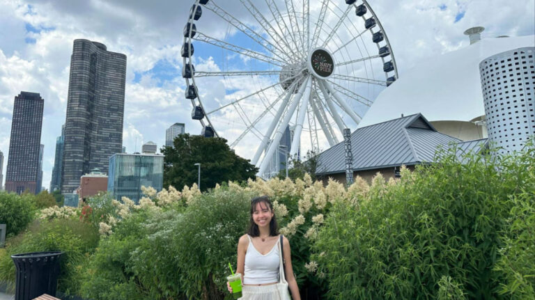 Travel Lemming author Lea Rose smiling brightly with the Navy Pier Centennial Wheel in her background