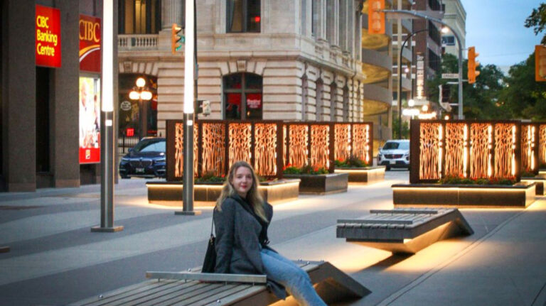 Travel Lemming author Taylor sitting in a bench at Downtown Winnipeg