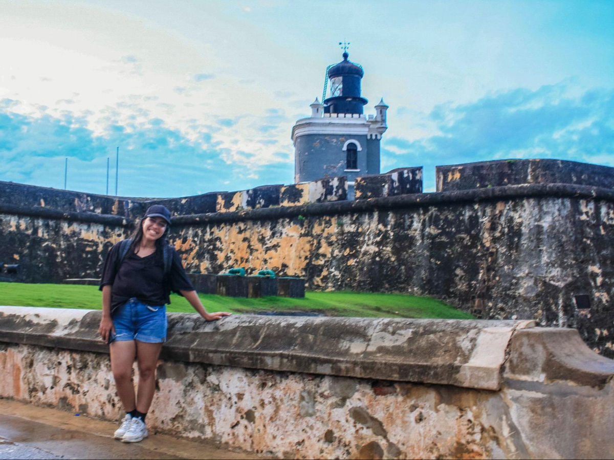 The author, Vanessa Ramos smiling for a photo in Castillo San Felipe del Morro