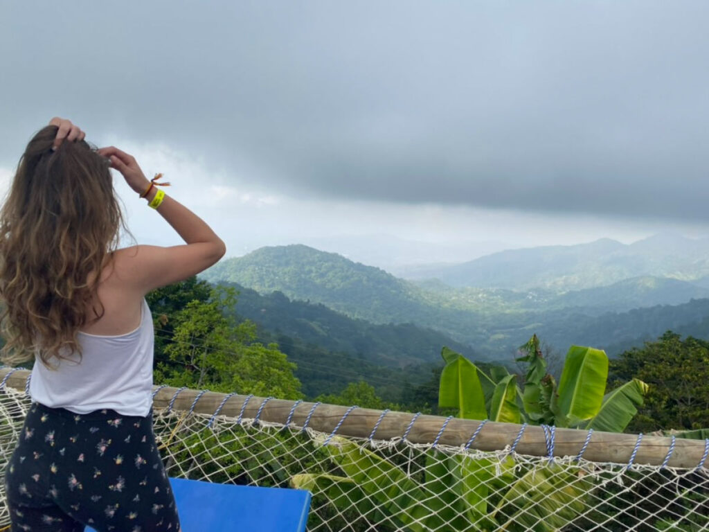 Travel writer Sky looking at the views on a giant hammock at Casa Elemento