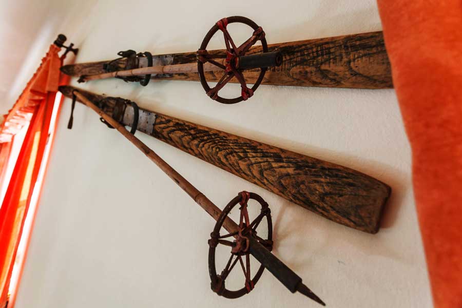 A vintage wooden skis display on a wall