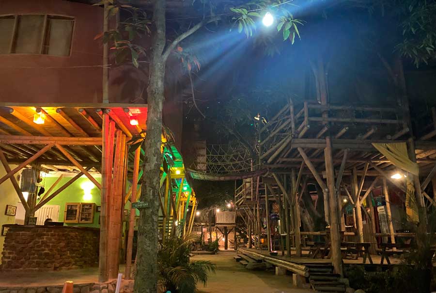 View of a treehouse-style hostel at night in Colombia