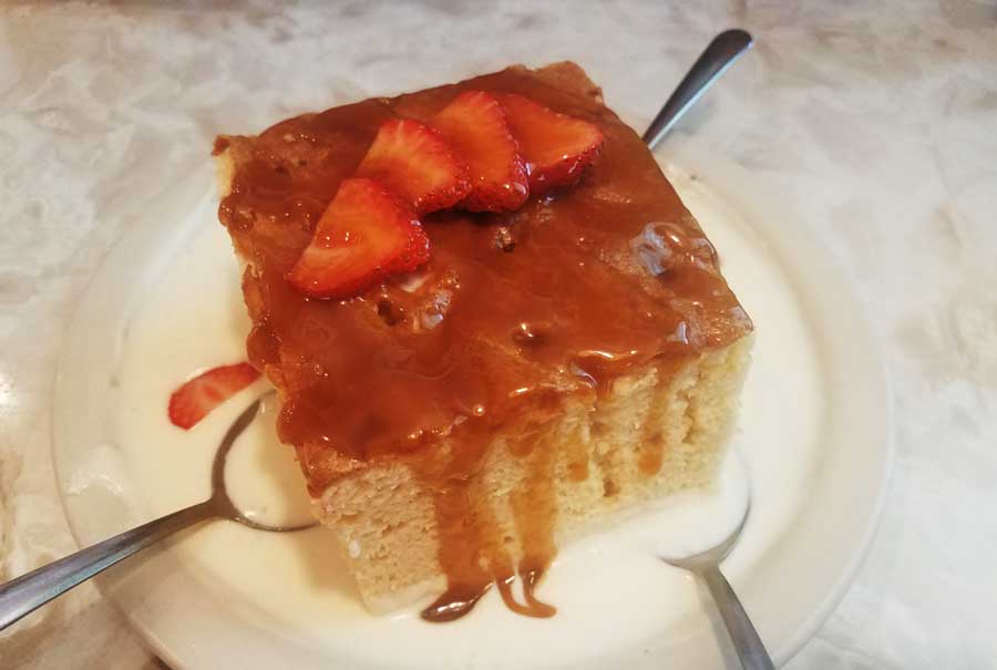 Tres Leches on a bowl with spoons