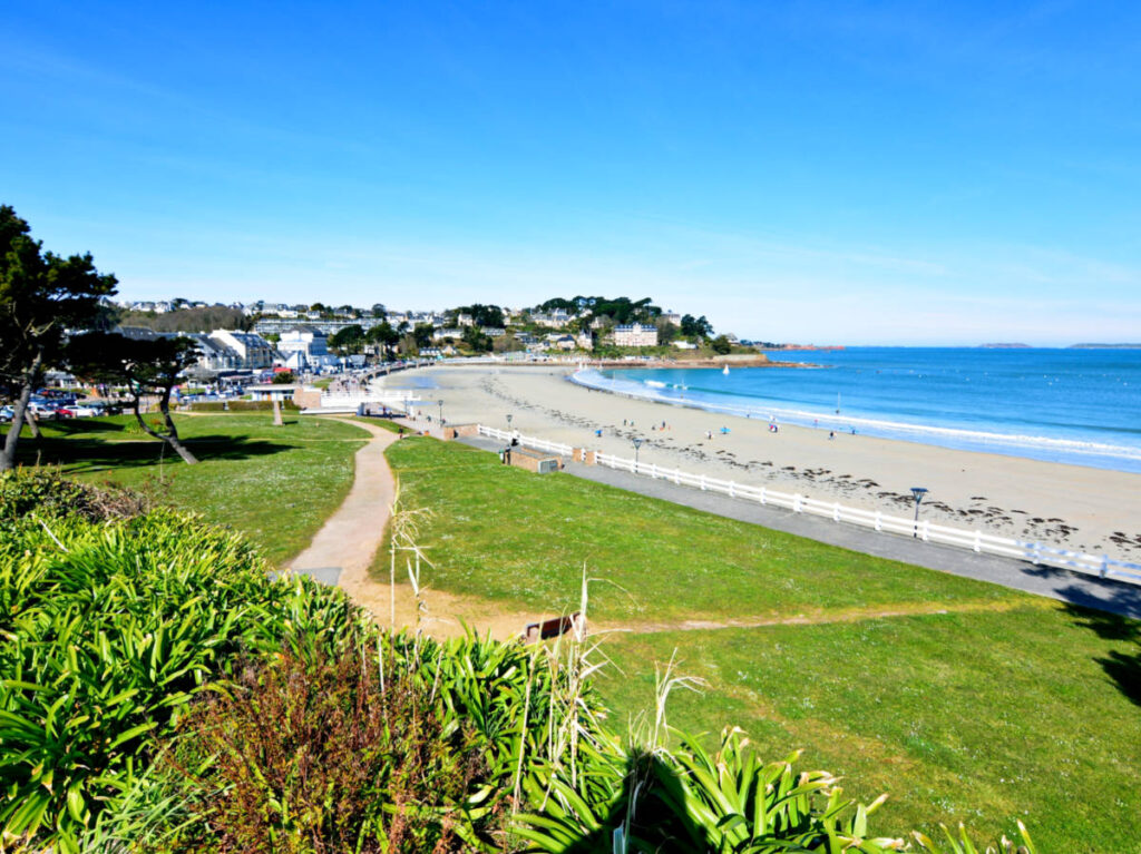 Overlooking view of the lush landscape, white sand and turquoise blue water of Trestraou Beach