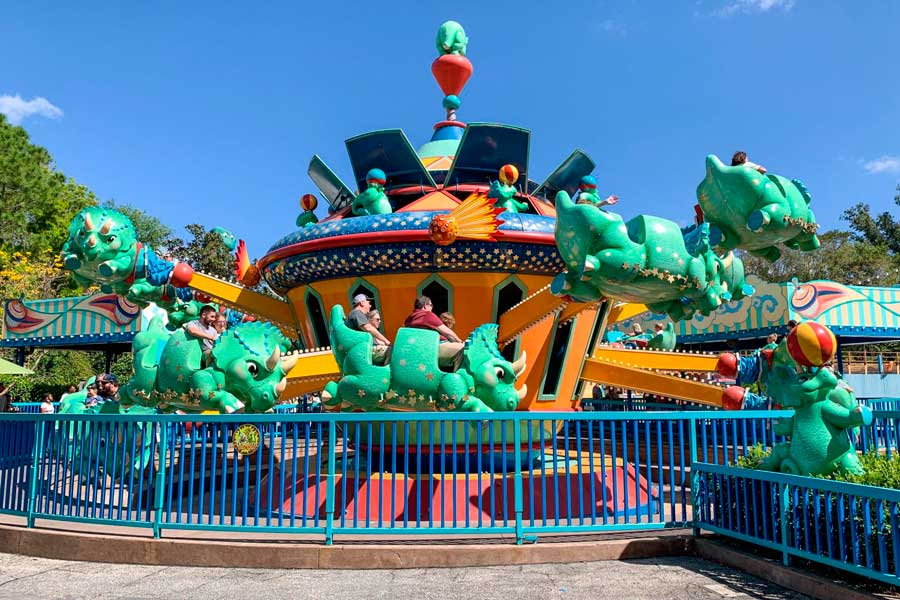 People enjoying the TriceraTop Spin attraction in Disney World