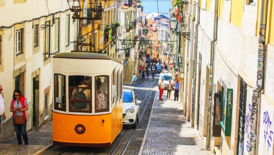 View of people and a trolley bus with passengers on it