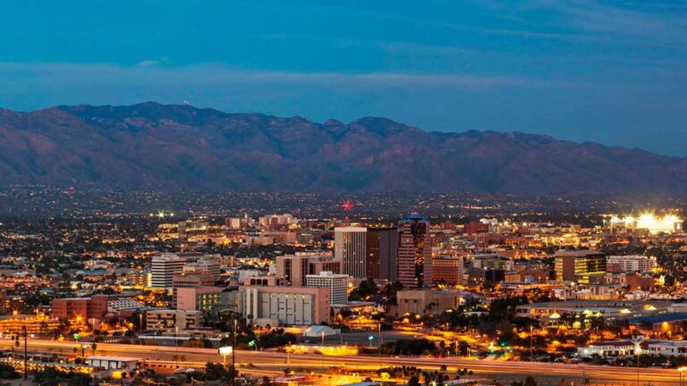 Aerial view of buildings with lights at night in Tucson