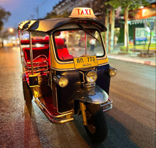 A tuk tuk at night in a road