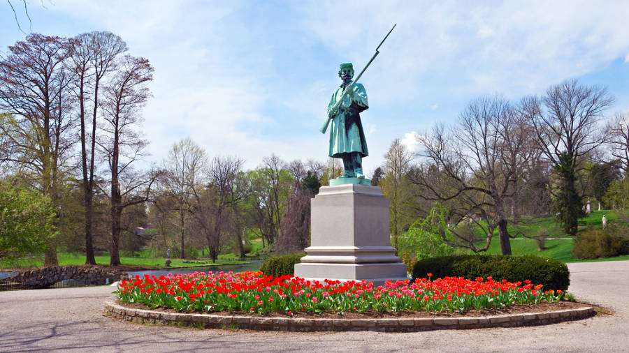 View of a statue surrounded by tulips at Spring Grove Cemetery