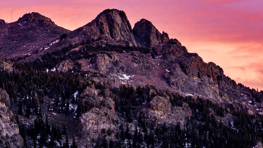 View of the Twin Sisters Peak with a vibrant sunset in the background