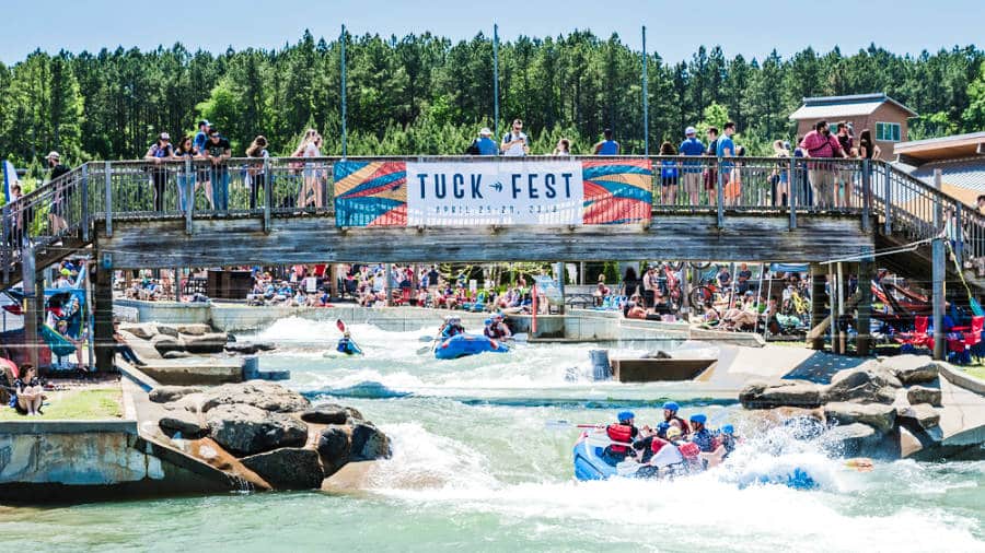 View of the crowd watching the people whitewater rafting at Tuck Fest
