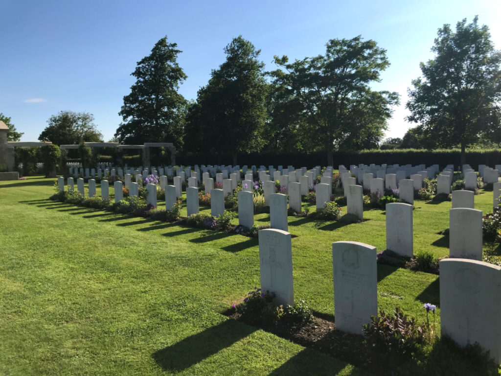 Headstones in grassy field at US cemetery in Normandy