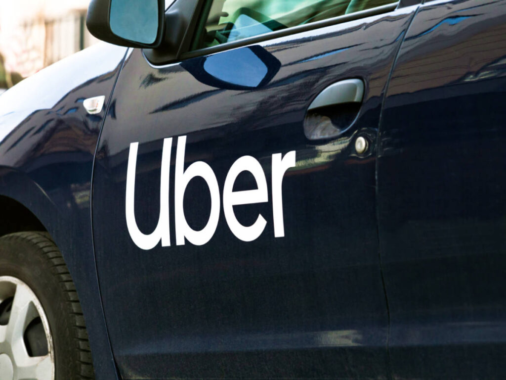 Closeup view of the logo of Uber on the car's door